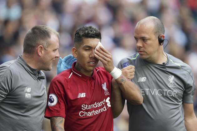 Liverpool's Roberto Firmino, holds a patch over his eye after he received a treatment during the English Premier League soccer match between Tottenham Hotspur and Liverpool at Wembley Stadium in London, Saturday Sept. 15, 2018. (AP Photo/Tim Ireland)