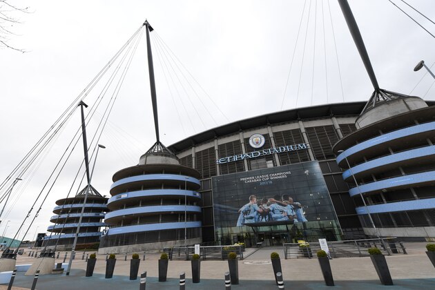 A new poster showing members of the Manchester City team celebrating has been placed at the entrance to the Etihad Stadium in Manchester, north west England to celebrate Manchester City winning the Premier League title on April 16, 2018.
Pep Guardiola's side were crowned kings of English football yesterday as their arch rivals Manchester United slumped to a shock 1-0 defeat against struggling West Bromwich Albion. / AFP PHOTO / Paul ELLIS / RESTRICTED TO EDITORIAL USE. No use with unauthorized audio, video, data, fixture lists, club/league logos or 'live' services. Online in-match use limited to 75 images, no video emulation. No use in betting, games or single club/league/player publications.  /         (Photo credit should read PAUL ELLIS/AFP/Getty Images)