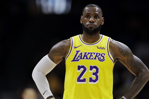 Los Angeles Lakers forward LeBron James looks on during the first half of an NBA preseason basketball game against the Denver Nuggets Sunday, Sept. 30, 2018, in San Diego. (AP Photo/Gregory Bull)