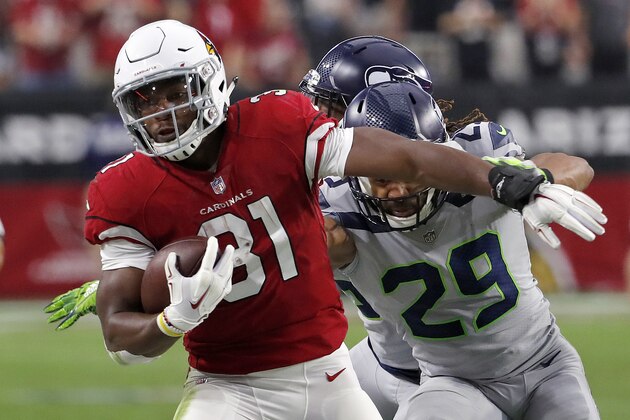 Arizona Cardinals running back David Johnson (31) runs as Seattle Seahawks defensive back Earl Thomas (29) defends during the first half of an NFL football game, Sunday, Sept. 30, 2018, in Glendale, Ariz. (AP Photo/Rick Scuteri)
