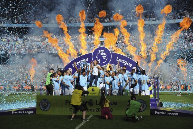 Manchester City players lift the English Premier League trophy after the soccer match between Manchester City and Huddersfield Town at Etihad stadium in Manchester, England, Sunday, May 6, 2018. (AP Photo/Rui Vieira)