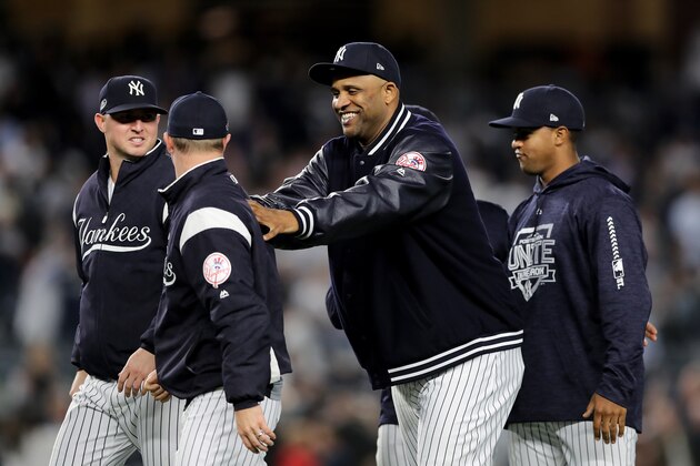 NEW YORK, NEW YORK - OCTOBER 03:  CC Sabathia #52 of the New York Yankees celebrates with his teammates after defeating the Oakland Athletics in the American League Wild Card Game at Yankee Stadium on October 03, 2018 in the Bronx borough of New York City. (Photo by Elsa/Getty Images)