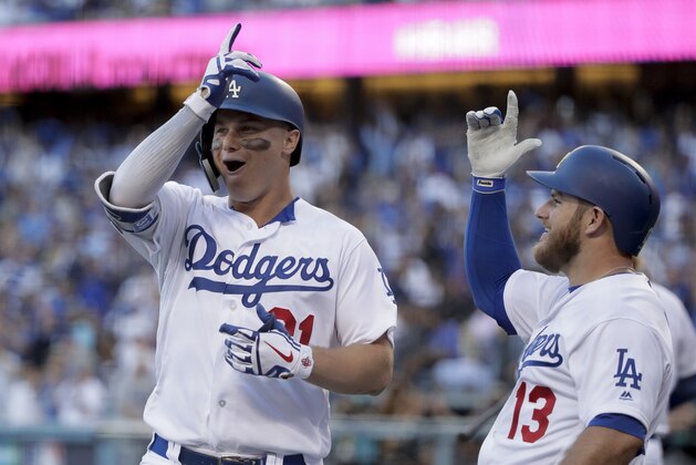 Los Angeles Dodgers left fielder Joc Pederson, left, celebrates his home run with Max Muncy during the first inning in Game 1 of a baseball National League Division Series against the Atlanta Braves on Thursday, Oct. 4, 2018, in Los Angeles. (AP Photo/Jae C. Hong)