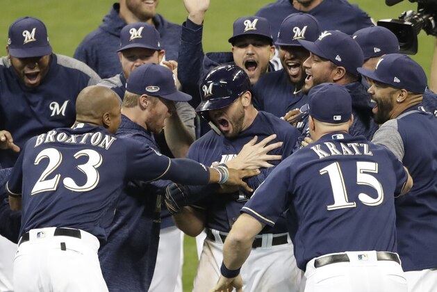 Milwaukee Brewers' Mike Moustakas reacts after hitting a walk off RBI single during the 10th inning of Game 1 of the National League Divisional Series baseball game against the Colorado Rockies Thursday, Oct. 4, 2018, in Milwaukee. The Brewers won 3-2 to take a 1-0 lead in the series. (AP Photo/Aaron Gash)