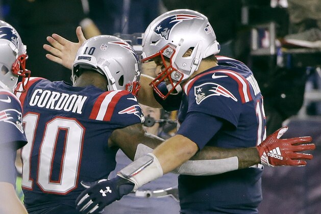 New England Patriots quarterback Tom Brady, right, celebrates his touchdown pass to wide receiver Josh Gordon (10) during the second half of an NFL football game against the Indianapolis Colts, Thursday, Oct. 4, 2018, in Foxborough, Mass. (AP Photo/Steven Senne)