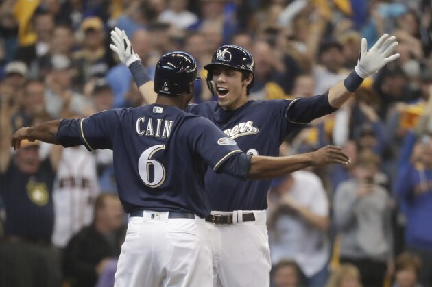 Milwaukee Brewers' Christian Yelich celebrates his two-run home run with Lorenzo Cain during the third inning of Game 1 of the National League Divisional Series baseball game against the Colorado Rockies Thursday, Oct. 4, 2018, in Milwaukee. (AP Photo/Morry Gash)