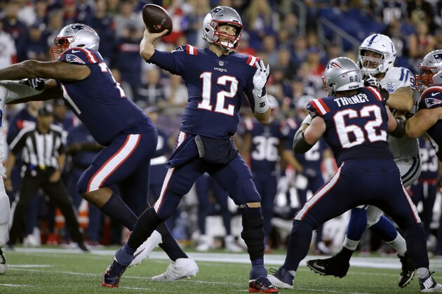 New England Patriots quarterback Tom Brady (12) passes under pressure from the Indianapolis Colts during the first half of an NFL football game, Thursday, Oct. 4, 2018, in Foxborough, Mass. (AP Photo/Steven Senne)