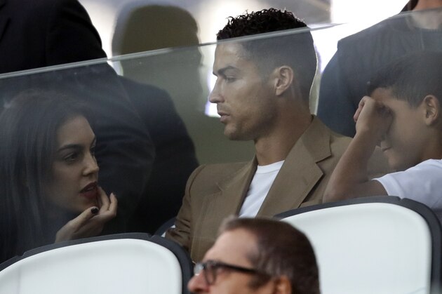 Juventus forward Cristiano Ronaldo and his partner Georgina sit in the stands prior to the Champions League, group H soccer match between Juventus and Young Boys, at the Allianz stadium in Turin, Italy, Tuesday, Oct. 2, 2018. (AP Photo/Luca Bruno)