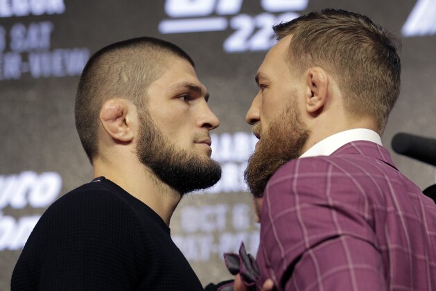 Conor McGregor, right, and Khabib Nurmagomedov pose for pictures during a news conference in New York, Thursday, Sept. 20, 2018. McGregor is returning to UFC after a two-year absence. He fights undefeated Nurmagomedov on Oct. 6. (AP Photo/Seth Wenig)