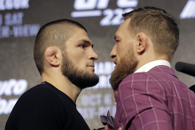 Conor McGregor, right, and Khabib Nurmagomedov pose for pictures during a news conference in New York, Thursday, Sept. 20, 2018. McGregor is returning to UFC after a two-year absence. He fights undefeated Nurmagomedov on Oct. 6. (AP Photo/Seth Wenig)
