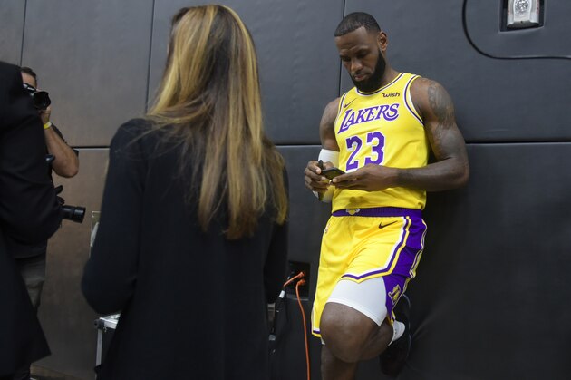 LeBron James checks his cellphone on arrival for his press conference on the Los Angeles Lakers in Los Angeles, California, September 24, 2018, with the Lakers' newest blockbuster signing and teammates met with the media. - The Lakers open their 2018 NBA season in Portland on October 18th. (Photo by Frederic J. BROWN / AFP)        (Photo credit should read FREDERIC J. BROWN/AFP/Getty Images)