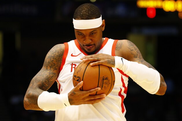 Houston Rockets forward Carmelo Anthony (7) rubs the ball before the start of the game against the Memphis Grizzlies during the first half of a preseason NBA basketball game, Tuesday, Oct. 2, 2018, in Birmingham, Ala. (AP Photo/Butch Dill)