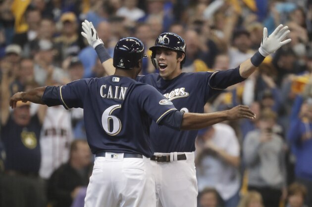 Milwaukee Brewers' Christian Yelich celebrates his two-run home run with Lorenzo Cain during the third inning of Game 1 of the National League Divisional Series baseball game against the Colorado Rockies Thursday, Oct. 4, 2018, in Milwaukee. (AP Photo/Morry Gash)