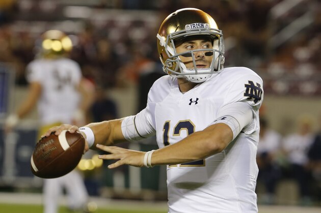 Notre Dame quarterback Ian Book (12) tosses a pass during warm ups prior to the start of an NCAA college football game in Blacksburg, Va., Saturday, Oct. 6, 2018. (AP Photo/Steve Helber)
