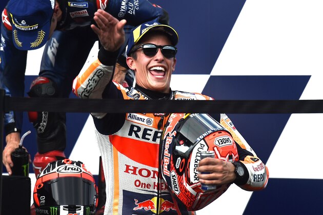 Repsol Honda Team's Spanish rider Marc Marquez celebrates on the podium after winning the MotoGP race of the inaugural Thailand Grand Prix at Buriram International Circuit on October 7, 2018. (Photo by Lillian SUWANRUMPHA / AFP)        (Photo credit should read LILLIAN SUWANRUMPHA/AFP/Getty Images)