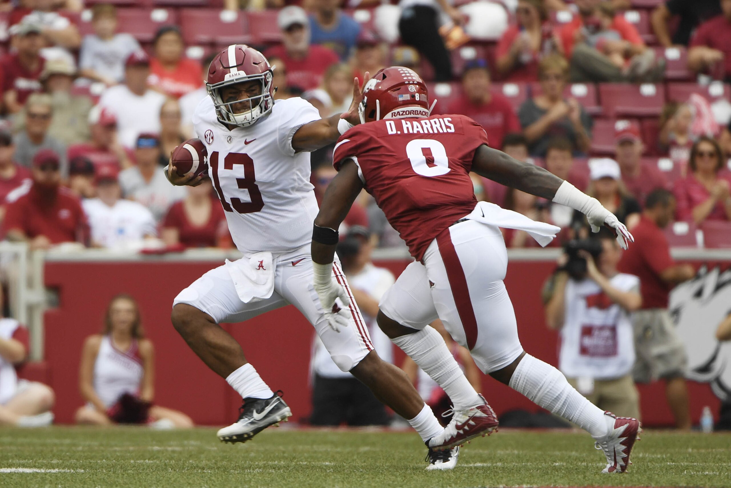 Alabama quarterback Tua Tagovailoa (13) tries to get away from Arkansas defender De'Jon Harris in the first half of an NCAA college football game Saturday, Oct. 6, 2018, in Fayetteville, Ark. (AP Photo/Michael Woods) Alabama quarterback Tua Tagovailoa (13) tries to get away from Arkansas defender De'Jon Harris in the first half of an NCAA college football game Saturday, Oct. 6, 2018, in Fayetteville, Ark. (AP Photo/Michael Woods)