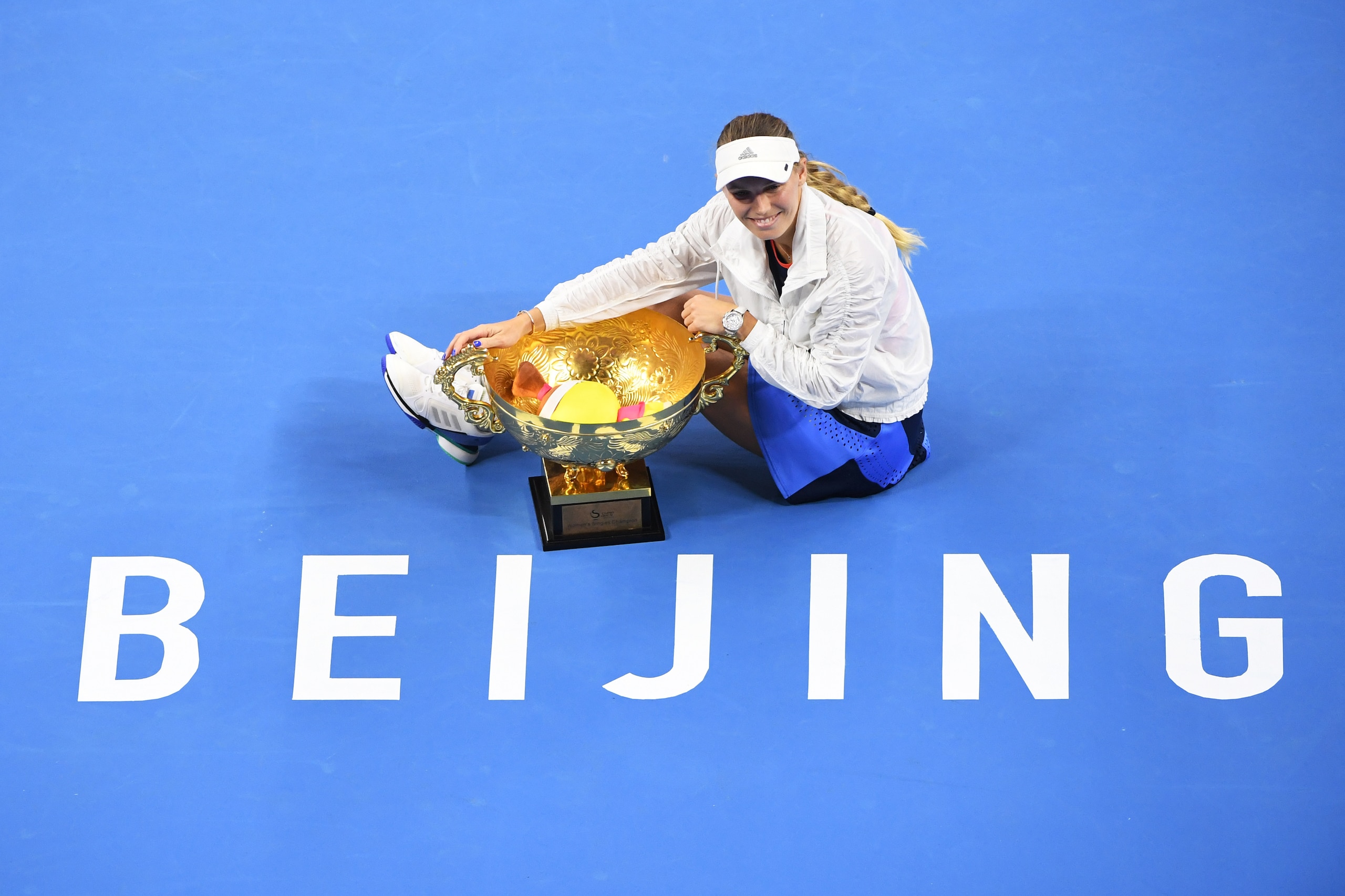 Caroline Wozniacki of Denmark poses with the trophy after winning the women's final against Anastasija Sevastova of Latvia at the China Open tennis tournament in Beijing on October 7, 2018. (Photo by GREG BAKER / AFP) (Photo credit should read GREG BAKER/AFP/Getty Images) Caroline Wozniacki of Denmark poses with the trophy after winning the women's final against Anastasija Sevastova of Latvia at the China Open tennis tournament in Beijing on October 7, 2018. (Photo by GREG BAKER / AFP) (Photo credit should read GREG BAKER/AFP/Getty Images)
