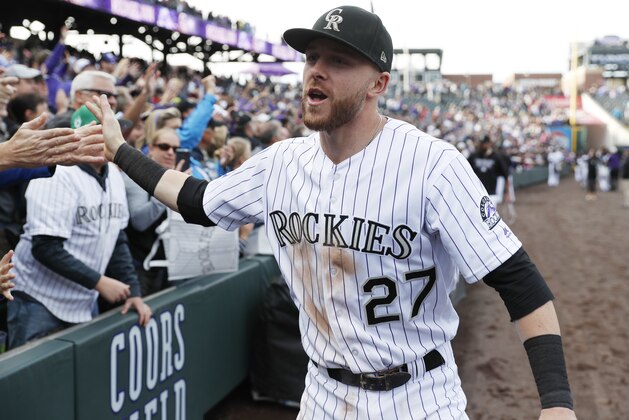 Colorado Rockies shortstop Trevor Story is congratulated by fans after the ninth inning of a baseball game against the Washington Nationals Sunday, Sept. 30, 2018, in Denver. The Rockies won 12-0. (AP Photo/David Zalubowski)