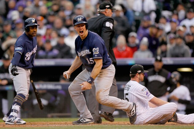 DENVER, CO - OCTOBER 07:  Erik Kratz #15 of the Milwaukee Brewers celebrates near teammate Curtis Granderson #28 after scoring on a wild pitch by Scott Oberg #45 who reacts on home plate putting the Brewers up 4-0 in the sixth inning of Game Three of the National League Division Series against the Colorado Rockies at Coors Field on October 7, 2018 in Denver, Colorado.  (Photo by Justin Edmonds/Getty Images)