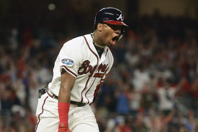 Atlanta Braves' Ronald Acuna Jr. (13) runs to first after hitting a grand-slam homer against Los Angeles Dodgers starting pitcher Walker Buehler during the second inning in Game 3 of MLB baseball's National League Division Series, Sunday, Oct. 7, 2018, in Atlanta. (AP Photo/John Amis)