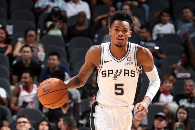 SAN ANTONIO, TX - OCTOBER 7: Dejounte Murray #5 of the San Antonio Spurs handles the ball against the Houston Rockets during a pre-season game on October 7, 2018 at AT&T Center, in San Antonio, Texas.  NOTE TO USER: User expressly acknowledges and agrees that, by downloading and/or using this Photograph, user is consenting to the terms and conditions of the Getty Images License Agreement. Mandatory Copyright Notice: Copyright 2018 NBAE (Photo by Nathaniel S. Butler/NBAE via Getty Images)