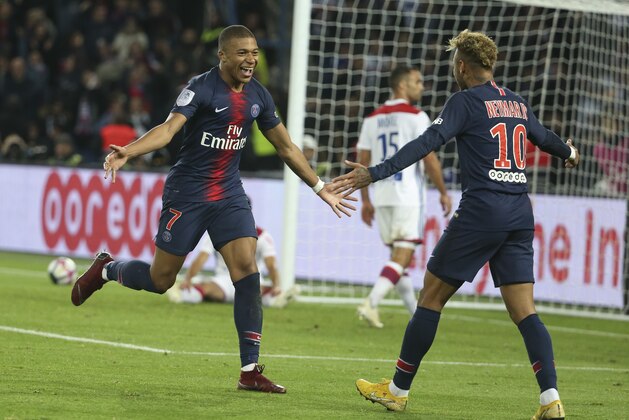 PARIS, FRANCE - OCTOBER 7: Kylian Mbappe of PSG celebrates his fourth goal with Neymar Jr during the french Ligue 1 match between Paris Saint-Germain (PSG) and Olympique Lyonnais (OL, Lyon) at Parc des Princes stadium on October 7, 2018 in Paris, France. (Photo by Jean Catuffe/Getty Images)