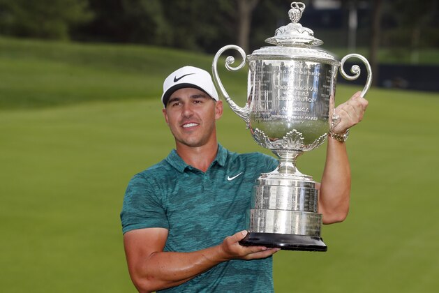 Brooks Koepka poses with the Wanamaker Trophy after winning the PGA Championship golf tournament at Bellerive Country Club, Sunday, Aug. 12, 2018, in St. Louis. (AP Photo/Jeff Roberson)