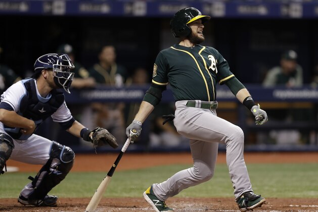 Oakland Athletics' Jed Lowrie lines an RBI single off Tampa Bay Rays pitcher Yonny Chirinos during the third inning of a baseball game, Saturday, Sept. 15, 2018, in St. Petersburg, Fla. A's Nick Martini scored on the play. Catching for the Rays is Nick Ciuffo. (AP Photo/Chris O'Meara)