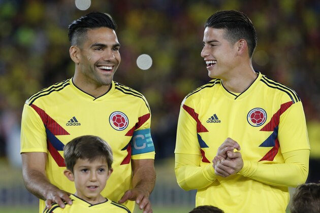 Colombia's James Rodriguez, right, and Radamel Falcao Garcia, laugh prior to an exhibition match at the Nemesio Camacho stadium in Bogota, Colombia, Friday, May 25, 2018. Colombia will warm up and play a friendly match against Egypt in Italy before heading to Russia for the 2018 FIFA World Cup. (AP Photo/Fernando Vergara)