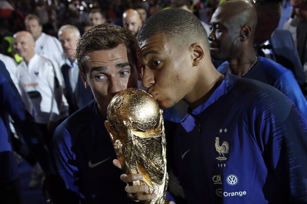 France's Kylian Mbappe, right, and and Antoine Griezmann kiss the World Cup trophy during a ceremony following the UEFA Nations League soccer match between France and The Netherlands at the Stade de France stadium in Saint-Denis, outside Paris, France, Sunday, Sept. 9, 2018. (AP Photo/Christophe Ena) France's Kylian Mbappe, right, and and Antoine Griezmann kiss the World Cup trophy during a ceremony following the UEFA Nations League soccer match between France and The Netherlands at the Stade de France stadium in Saint-Denis, outside Paris, France, Sunday, Sept. 9, 2018. (AP Photo/Christophe Ena)