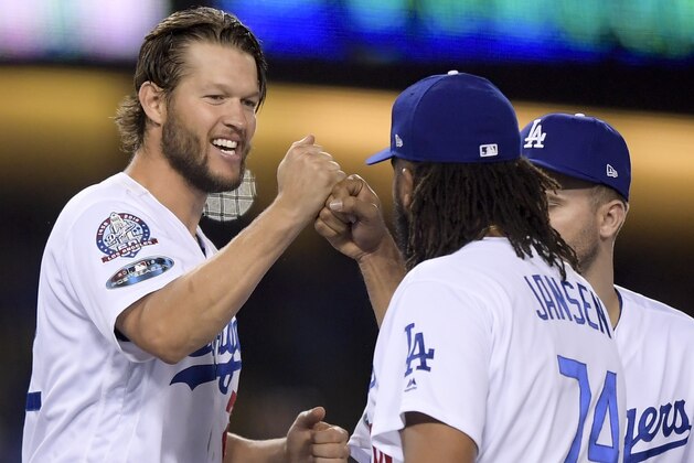 Los Angeles Dodgers starting pitcher Clayton Kershaw celebrates after with relief pitcher Kenley Jansen after the Dodgers' 3-0 win against the Atlanta Braves in Game 2 of a baseball National League Division Series on Friday, Oct. 5, 2018, in Los Angeles. (AP Photo/Mark J. Terrill)