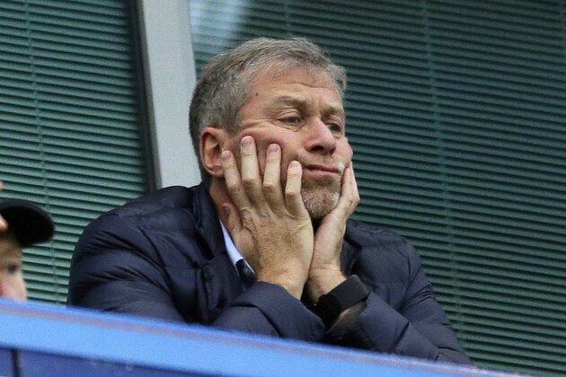 FILE - In this Saturday, Dec. 19, 2015 file photo, Chelsea soccer club owner Roman Abramovich sits in his box before the English Premier League soccer match between Chelsea and Sunderland at Stamford Bridge stadium in London. Roman Abramovich withdrew an application for residency in Switzerland, according to the Swiss migration office, as lawyers for the Russian oligarch lashed out at “defamatory” allegations involving money laundering and denied that he has links to organized crime. (AP Photo/Matt Dunham, File)