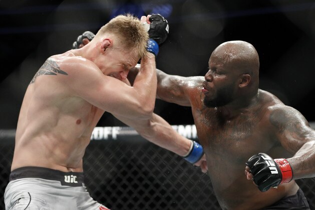 Derrick Lewis, right, punches Alexander Volkov during a heavyweight mixed martial arts bout at UFC 229 in Las Vegas, Saturday, Oct. 6, 2018. Lewis won by knockout in the third round. (AP Photo/John Locher)