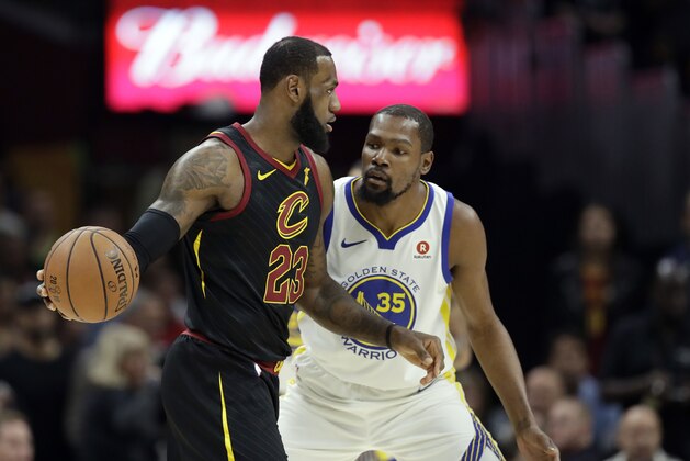 Cleveland Cavaliers' LeBron James is defended by Golden State Warriors' Kevin Durant in the first half of Game 3 of basketball's NBA Finals, Wednesday, June 6, 2018, in Cleveland. (AP Photo/Tony Dejak)