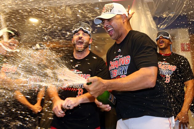 NEW YORK, NEW YORK - OCTOBER 09:  Alex Cora #20 of the Boston Red Sox celebrates in the locker room with his team after defeating the New York Yankees to win Game Four American League Division Series by a score of 4-3 at Yankee Stadium on October 09, 2018 in the Bronx borough of New York City. (Photo by Elsa/Getty Images)