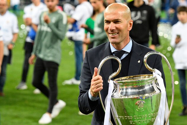 Real Madrid's French coach Zinedine Zidane poses with the trophy after winning  the UEFA Champions League final football match between Liverpool and Real Madrid at the Olympic Stadium in Kiev, Ukraine, on May 26, 2018. (Photo by GENYA SAVILOV / AFP)        (Photo credit should read GENYA SAVILOV/AFP/Getty Images)