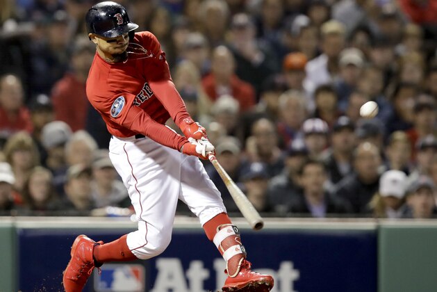 Boston Red Sox's Mookie Betts hits a double against the New York Yankees during the third inning of Game 1 of a baseball American League Division Series on Friday, Oct. 5, 2018, in Boston. (AP Photo/Charles Krupa)