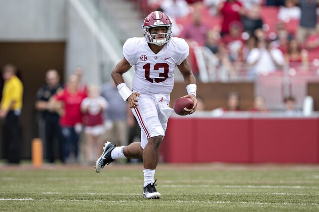 FAYETTEVILLE, AR - OCTOBER 6:  Tua Tagovailoa #13 of the Alabama Crimson Tide runs the ball during a game against the Arkansas Razorbacks at Razorback Stadium on October 6, 2018 in Tuscaloosa, Alabama.  The Crimson Tide defeated the Razorbacks 65-31.  (Photo by Wesley Hitt/Getty Images)