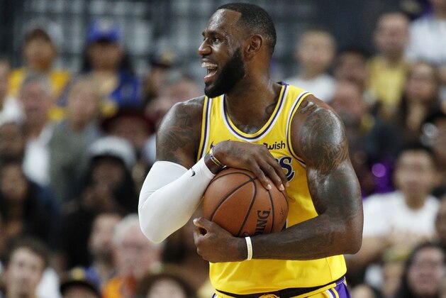 Los Angeles Lakers forward LeBron James reacts after a play against the Golden State Warriors during the first half of an NBA preseason basketball game Wednesday, Oct. 10, 2018, in Las Vegas. (AP Photo/John Locher)