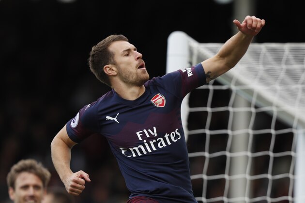 Arsenal's Welsh midfielder Aaron Ramsey celebrates after scoring the team's third goal during the English Premier League football match between Fulham and Arsenal at Craven Cottage in London on October 7, 2018. (Photo by Adrian DENNIS / AFP) / RESTRICTED TO EDITORIAL USE. No use with unauthorized audio, video, data, fixture lists, club/league logos or 'live' services. Online in-match use limited to 120 images. An additional 40 images may be used in extra time. No video emulation. Social media in-match use limited to 120 images. An additional 40 images may be used in extra time. No use in betting publications, games or single club/league/player publications. /         (Photo credit should read ADRIAN DENNIS/AFP/Getty Images)