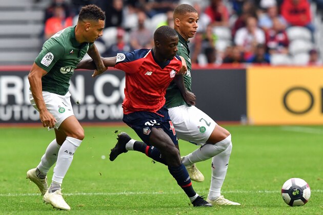 Lille's Ivorian forward Nicolas Pepe (C) vies with Saint-Etienne's French defender Timothee Kolodziejczak (L) and Saint-Etienne's French forward Kevin Monnet-Paquet (R) during the French L1 football match between Lille and Saint-Etienne at the Pierre-Mauroy Stadium in Villeneuve d'Ascq, northern France, on October 6, 2018. (Photo by DENIS CHARLET / AFP)        (Photo credit should read DENIS CHARLET/AFP/Getty Images)