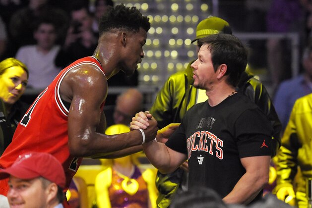 Chicago Bulls guard Jimmy Butler, left, talks with actor Mark Wahlberg during the first half of an NBA basketball game between the Los Angeles Lakers and the Bulls, Thursday, Jan. 28, 2016, in Los Angeles. (AP Photo/Mark J. Terrill)
