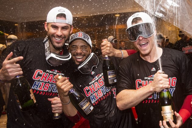 NEW YORK, NY - OCTOBER 9: J.D. Martinez #28, Mookie Betts #50, and Brock Holt #12 of the Boston Red Sox pose for a photograph as they celebrate with champagne in the clubhouse after clinching the American League Division Series in game four against the New York Yankees on October 9, 2018 at Yankee Stadium in the Bronx borough of New York City. (Photo by Billie Weiss/Boston Red Sox/Getty Images)