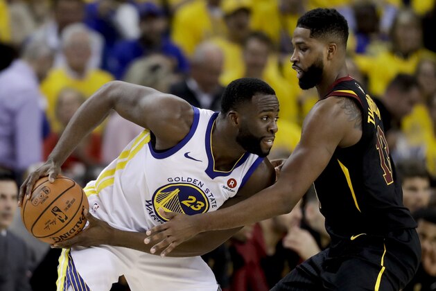 Golden State Warriors forward Draymond Green (23) is defended by Cleveland Cavaliers center Tristan Thompson during the second half of Game 1 of basketball's NBA Finals in Oakland, Calif., Thursday, May 31, 2018. (AP Photo/Marcio Jose Sanchez)