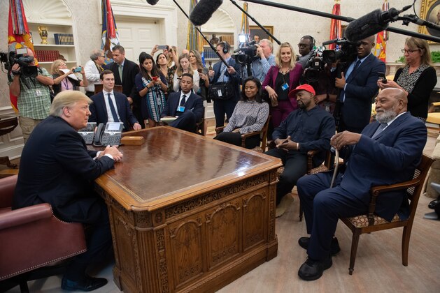 US President Donald Trump meets with rapper Kanye West and former football player Jim Brown (R) in the Oval Office of the White House in Washington, DC, October 11, 2018. (Photo by SAUL LOEB / AFP)        (Photo credit should read SAUL LOEB/AFP/Getty Images)