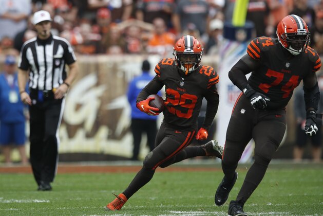 Cleveland Browns running back Duke Johnson (29) follows the block of offensive tackle Chris Hubbard (74) during an NFL game against the Baltimore Ravens, Sunday, Oct. 7, 2018, in Cleveland. The Browns won 12-9 in overtime. (Jeff Haynes/AP Images for Panini)