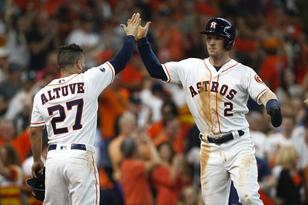 HOUSTON, TX - OCTOBER 06:  Alex Bregman #2 of the Houston Astros celebrates with Jose Altuve #27 after scoring a run in the sixth inning against the Cleveland Indians during Game Two of the American League Division Series at Minute Maid Park on October 6, 2018 in Houston, Texas.  (Photo by Bob Levey/Getty Images)