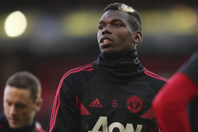Manchester United's Paul Pogba takes part in the warm up ahead of the English Premier League soccer match between Manchester United and Newcastle United at Old Trafford in Manchester, England, Saturday, Oct. 6, 2018. (AP Photo/Jon Super)