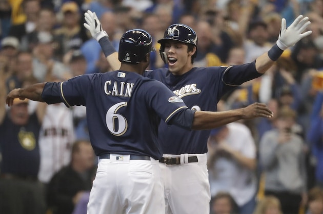 Milwaukee Brewers' Christian Yelich celebrates his two-run home run with Lorenzo Cain during the third inning of Game 1 of the National League Divisional Series baseball game against the Colorado Rockies Thursday, Oct. 4, 2018, in Milwaukee. (AP Photo/Morry Gash)