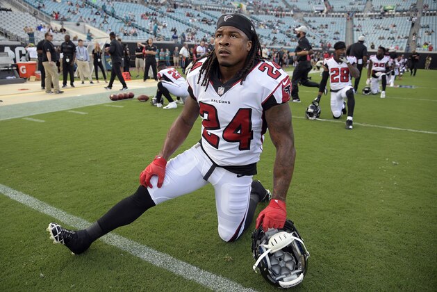 FILE - In this Aug. 25, 2018, file photo, Atlanta Falcons running back Devonta Freeman (24) stretches before an NFL preseason football game against the Jacksonville Jaguars in Jacksonville, Fla. Freeman has been ruled out for Sunday’s game against Carolina because of a knee injury, coach Dan Quinn said Friday, Sept. 14, 2018. (AP Photo/Phelan M. Ebenhack, File)
